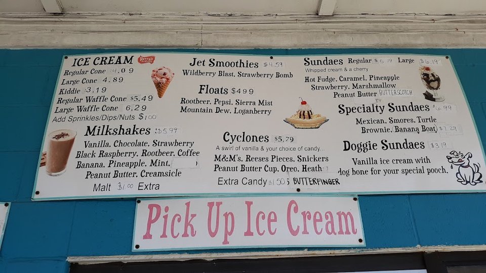 Menu board for burgers, hot dogs, and fries.